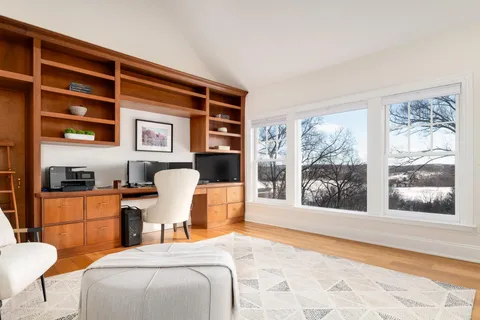 a bedroom with a bed and glass window