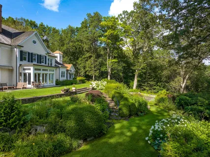 a view of an house with swimming pool and sitting area