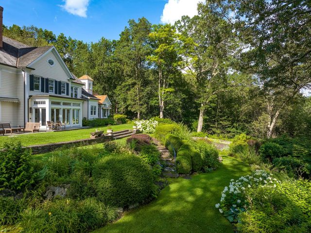 a view of an house with swimming pool and sitting area