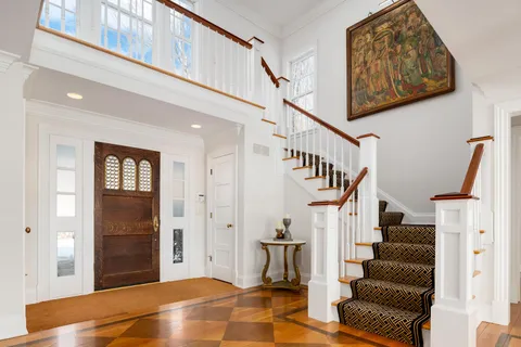 a view of entryway with wooden floor and stairs