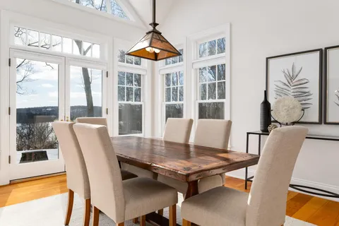 a view of a dining room with furniture window and wooden floor