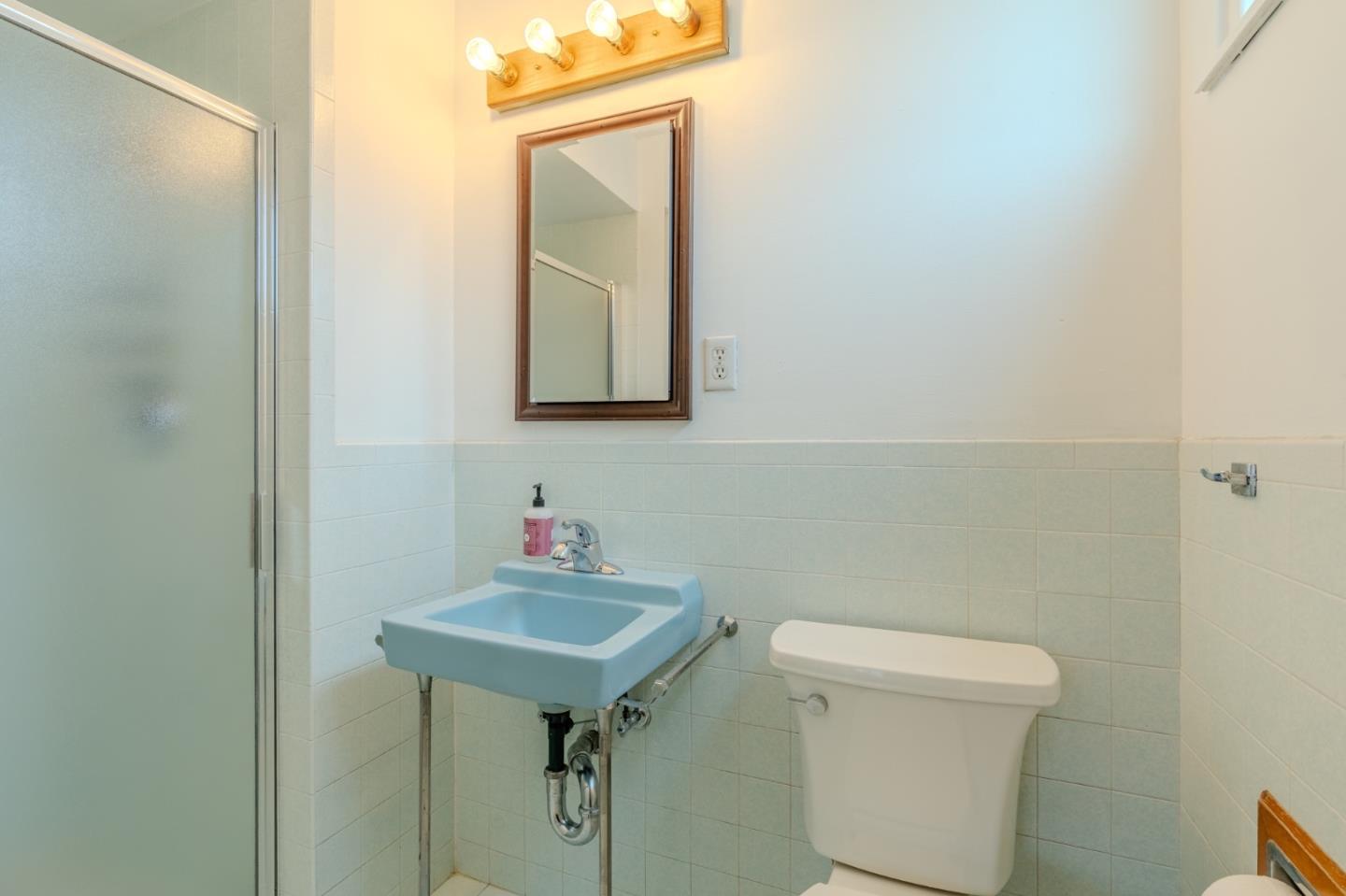 226 Crestmoor Circle Pacifica, CA 94044 - Photo 14 of 23 a bathroom with a toilet a sink and mirror