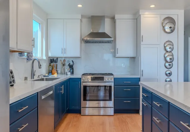a kitchen with stainless steel appliances granite countertop a stove and a sink