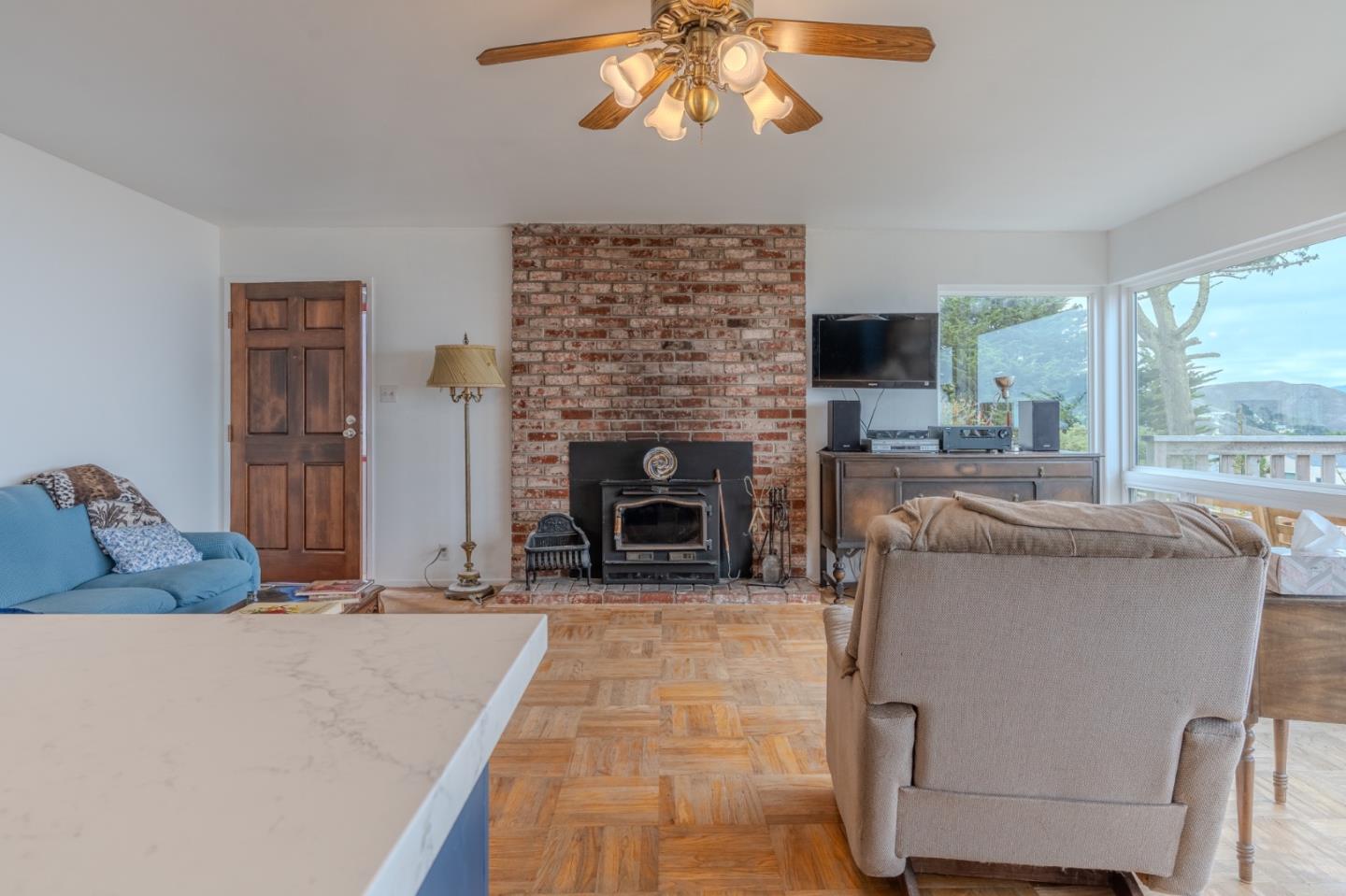226 Crestmoor Circle Pacifica, CA 94044 - Photo 4 of 23 a living room with furniture a fireplace and a large window