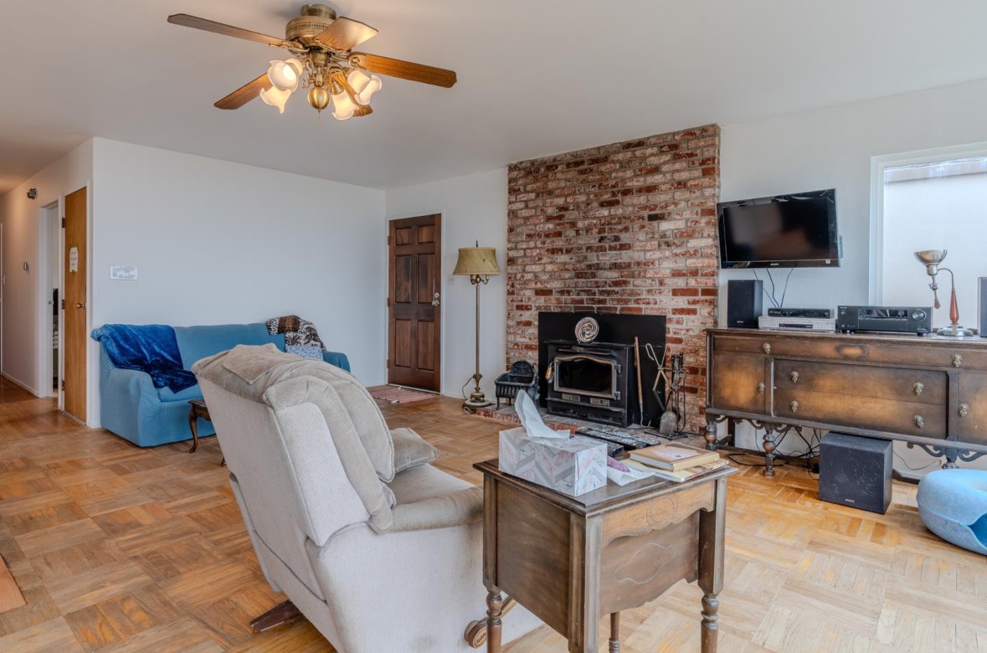 226 Crestmoor Circle Pacifica, CA 94044 - Photo 5 of 23 a living room with furniture a flat screen tv and a fireplace