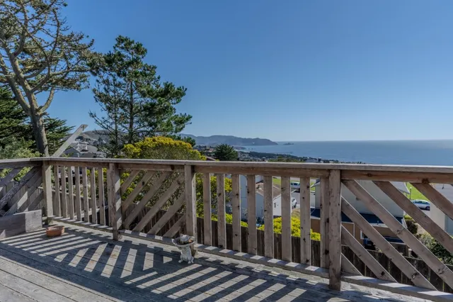 a view of a balcony with wooden floor
