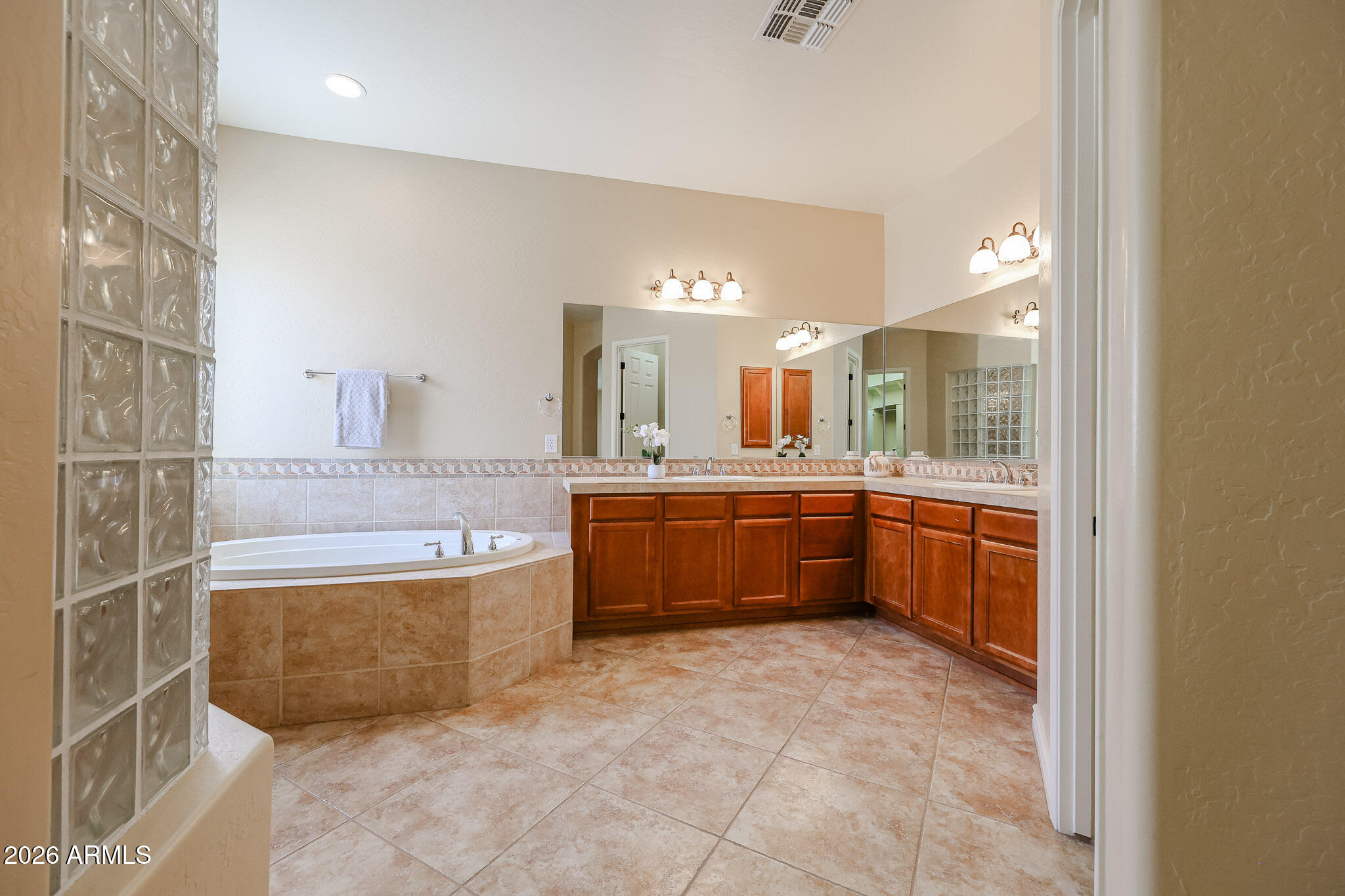 18175 West Narramore Road Goodyear, AZ 85338 - Photo 32 of 72 a large bathroom with a tub a sink and mirror