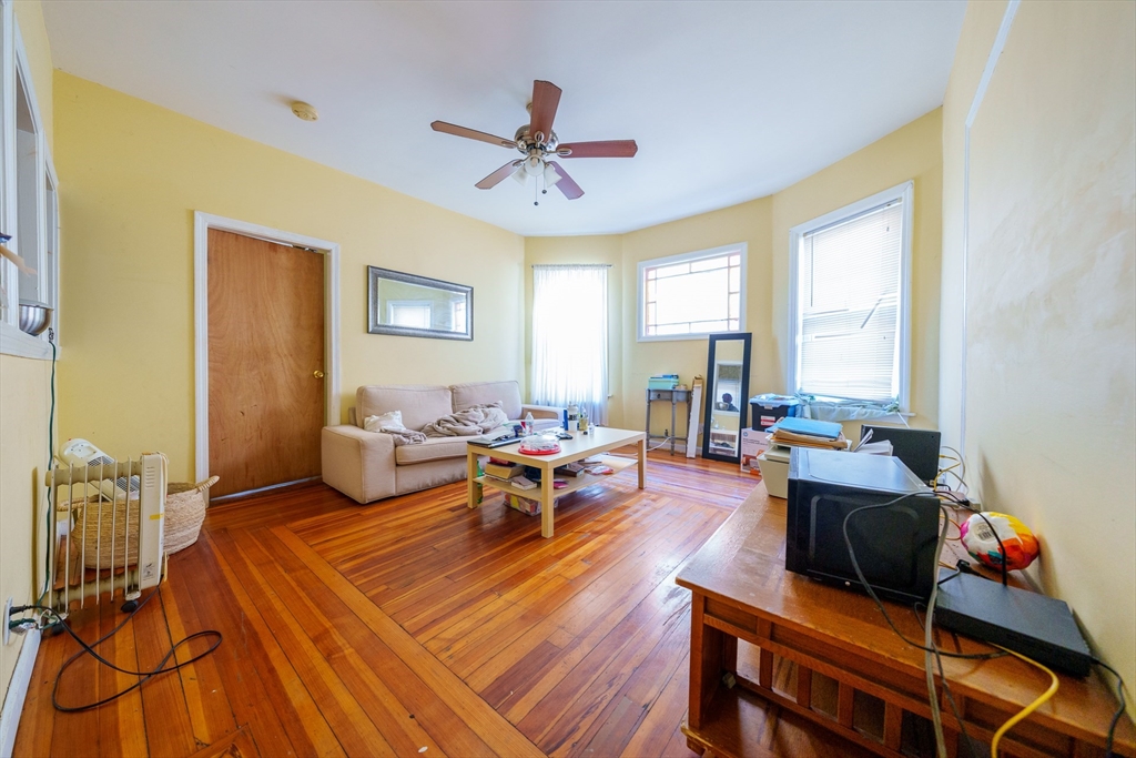 41 Derby Street, Unit 1 Somerville, MA 02145 - Photo 1 of 6 a living room with furniture and a window