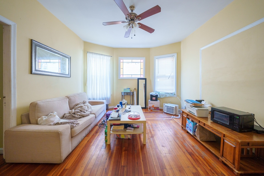 41 Derby Street, Unit 1 Somerville, MA 02145 - Photo 2 of 6 a living room with furniture and a wooden floor