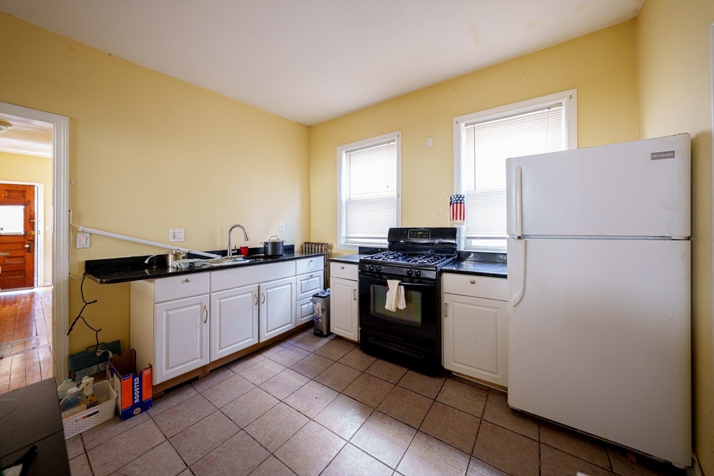 41 Derby Street, Unit 1 Somerville, MA 02145 - Photo 4 of 6 a kitchen with a refrigerator and a stove