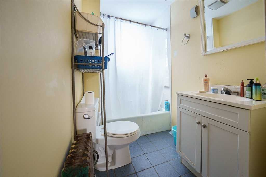 41 Derby Street, Unit 1 Somerville, MA 02145 - Photo 6 of 6 a bathroom with a toilet sink and mirror