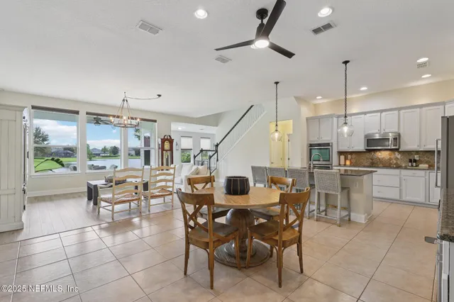 a large kitchen with a table and chairs