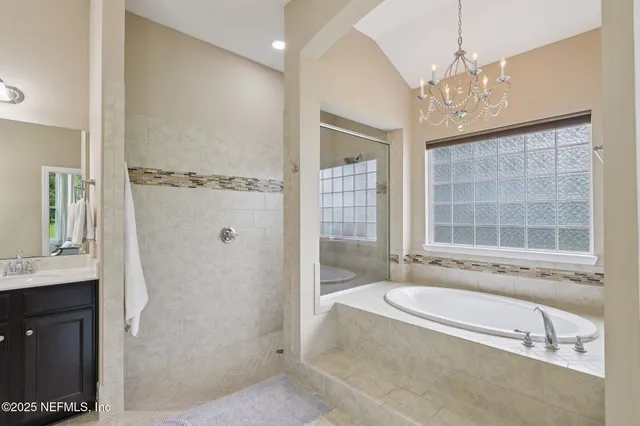 a spacious bathroom with a granite countertop tub sink and mirror