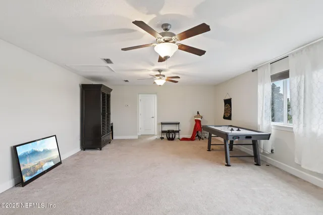 a work room with furniture and a ceiling fan
