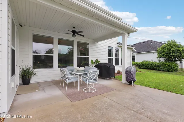 a view of a patio with table and chairs and potted plants