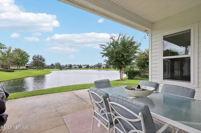 a view of house with backyard and lake view