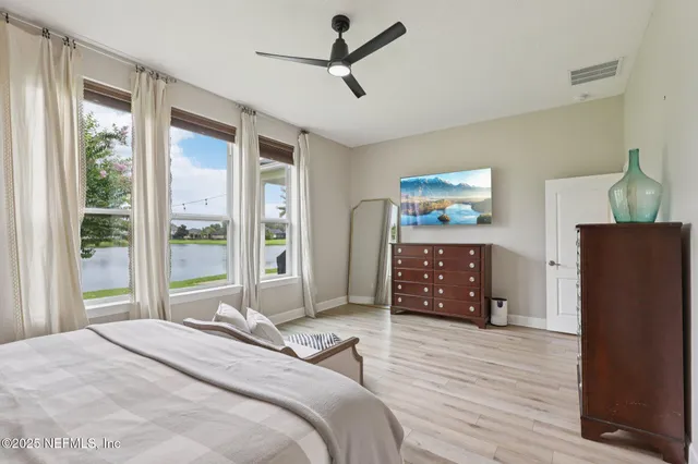 a bedroom with a bed dresser and a window