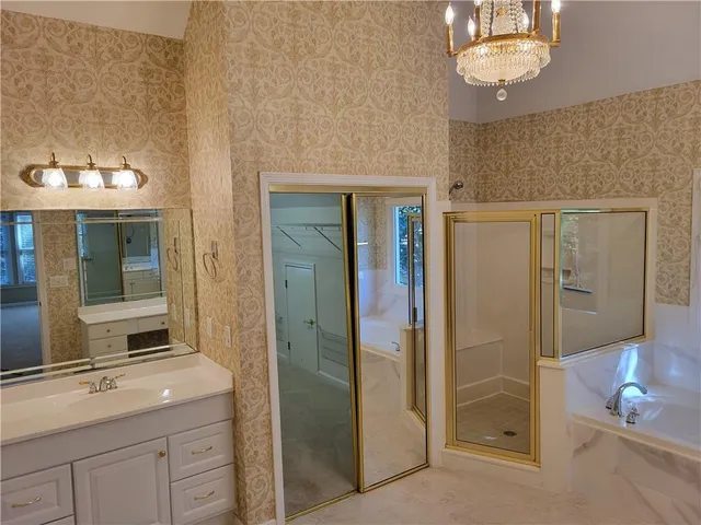 a bathroom with a sink a mirror and a shower