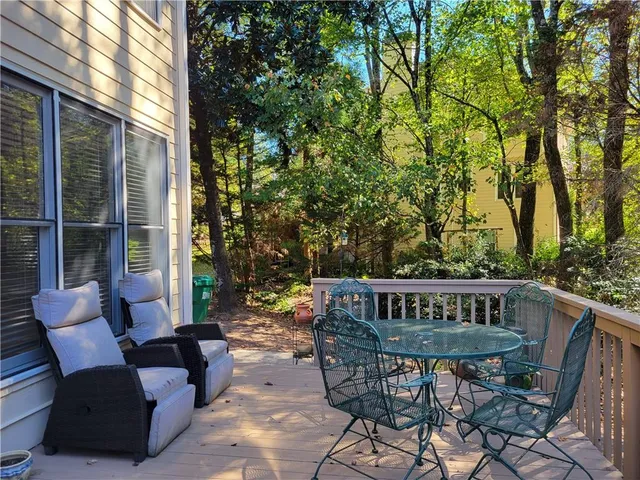 a view of a chair and table on the deck