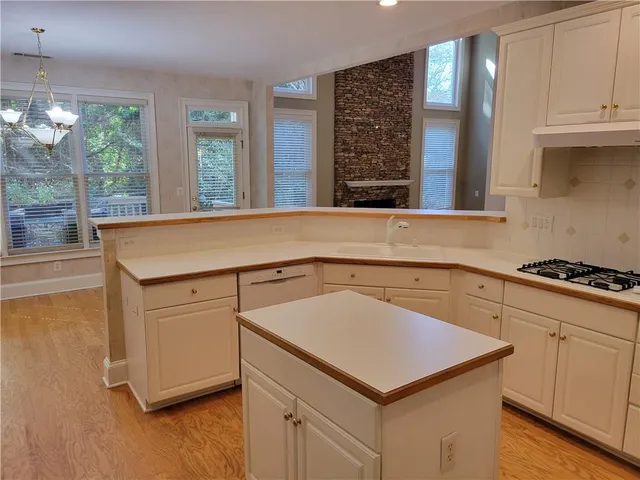 a kitchen with a sink cabinets and a window