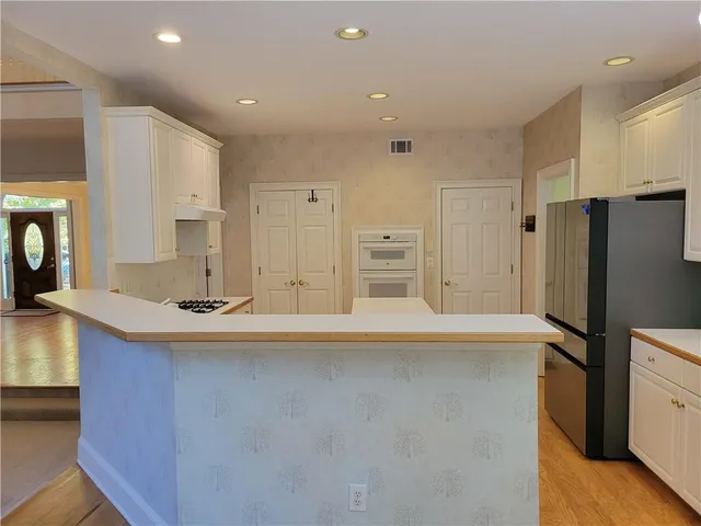 a kitchen with stainless steel appliances a refrigerator and a stove