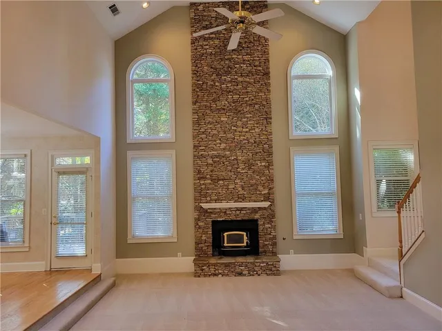 a view of a livingroom with a fireplace and window