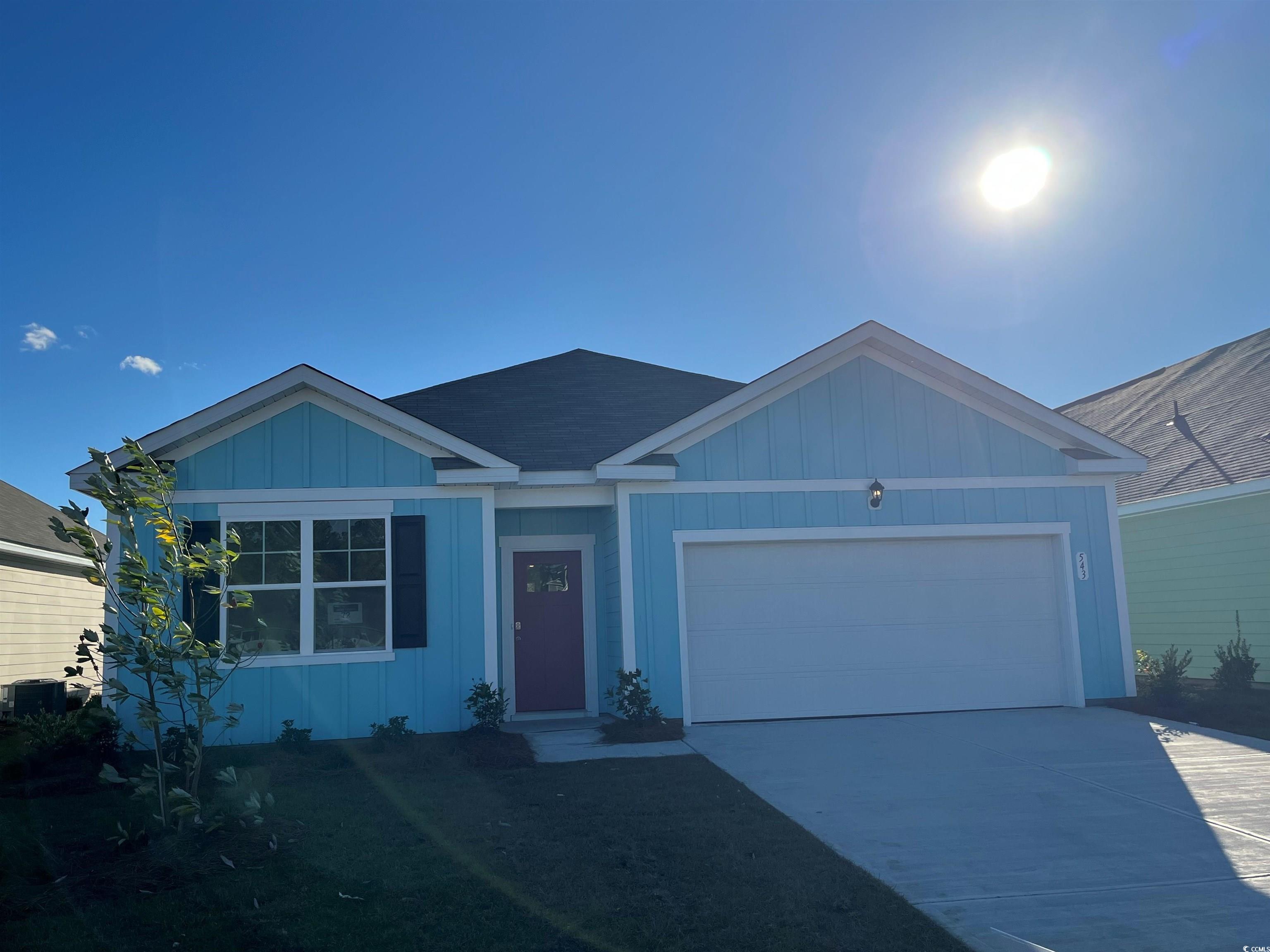 543 Duvall Street Longs, SC 29568 - Photo 1 of 16 Ranch-style house featuring a garage, driveway, and board and batten siding