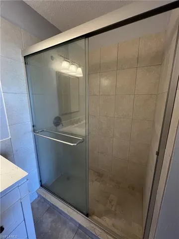 a bathroom with a glass shower door