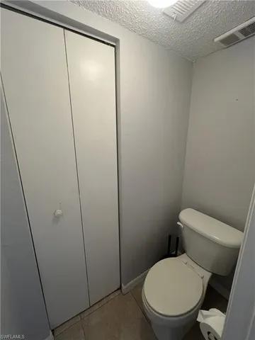 a white toilet sitting next to a shower