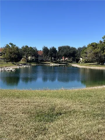 an aerial view of residential houses with outdoor space and lake view