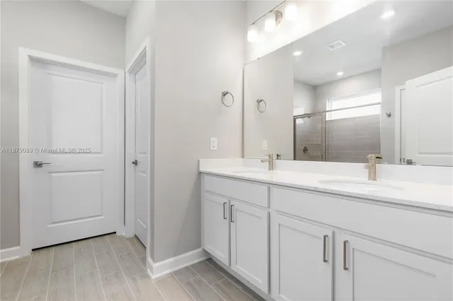 a bathroom with a double vanity sink and a mirror