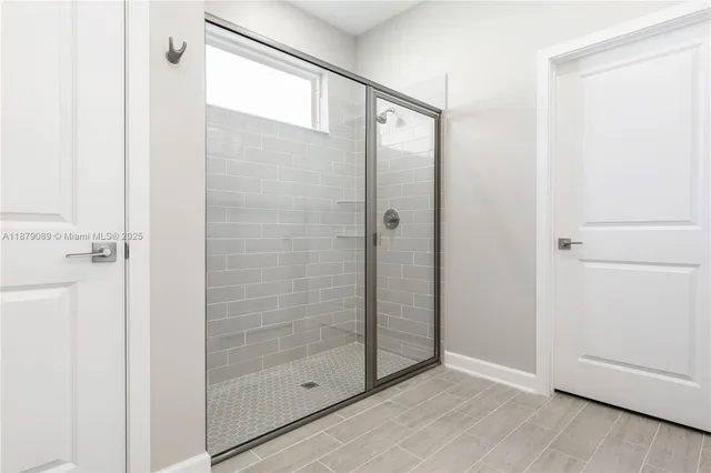 a bathroom with a glass shower door