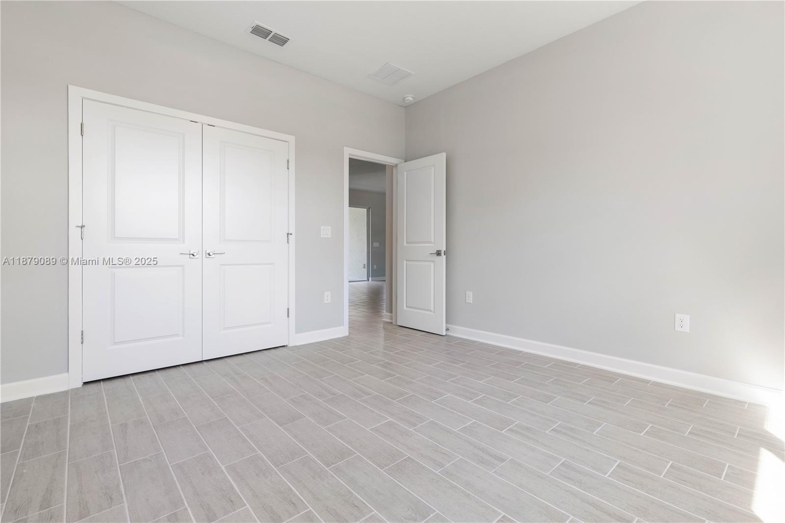 570 Town Road Southwest Palm Bay, FL 32908 - Photo 20 of 26 a view of an empty room and wooden floor