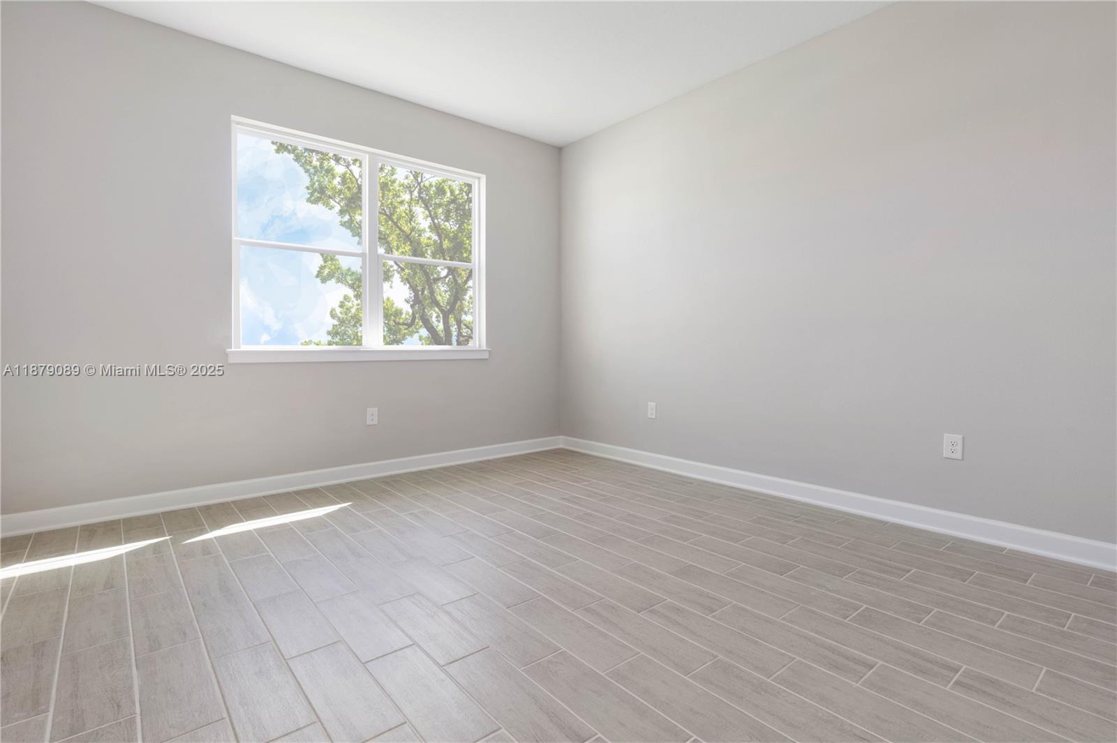 570 Town Road Southwest Palm Bay, FL 32908 - Photo 21 of 26 an empty room with wooden floor and windows
