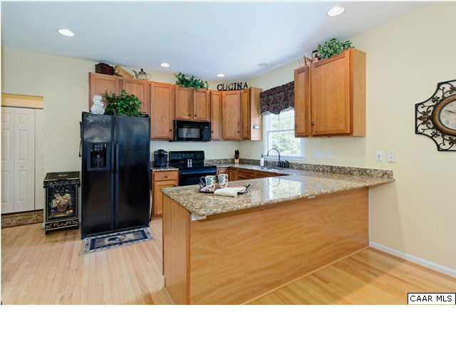 3771 Ashleigh Way Road Barboursville, VA 22923 - Photo 10 of 26 Cherry cabinets, granite countertops and hardwood floors enhance the beauty of this inviting kitchen.
