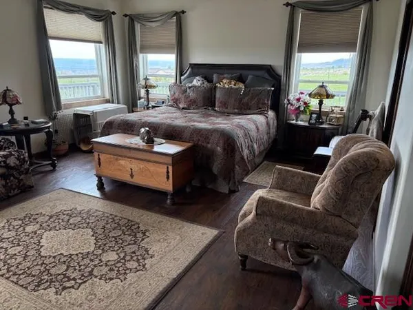 a bedroom with bed couch and window