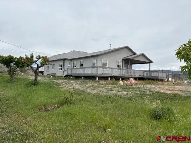 a view of a house with a backyard and a garden