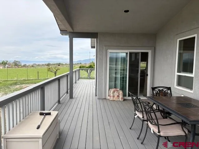a view of balcony with wooden floor and outdoor seating