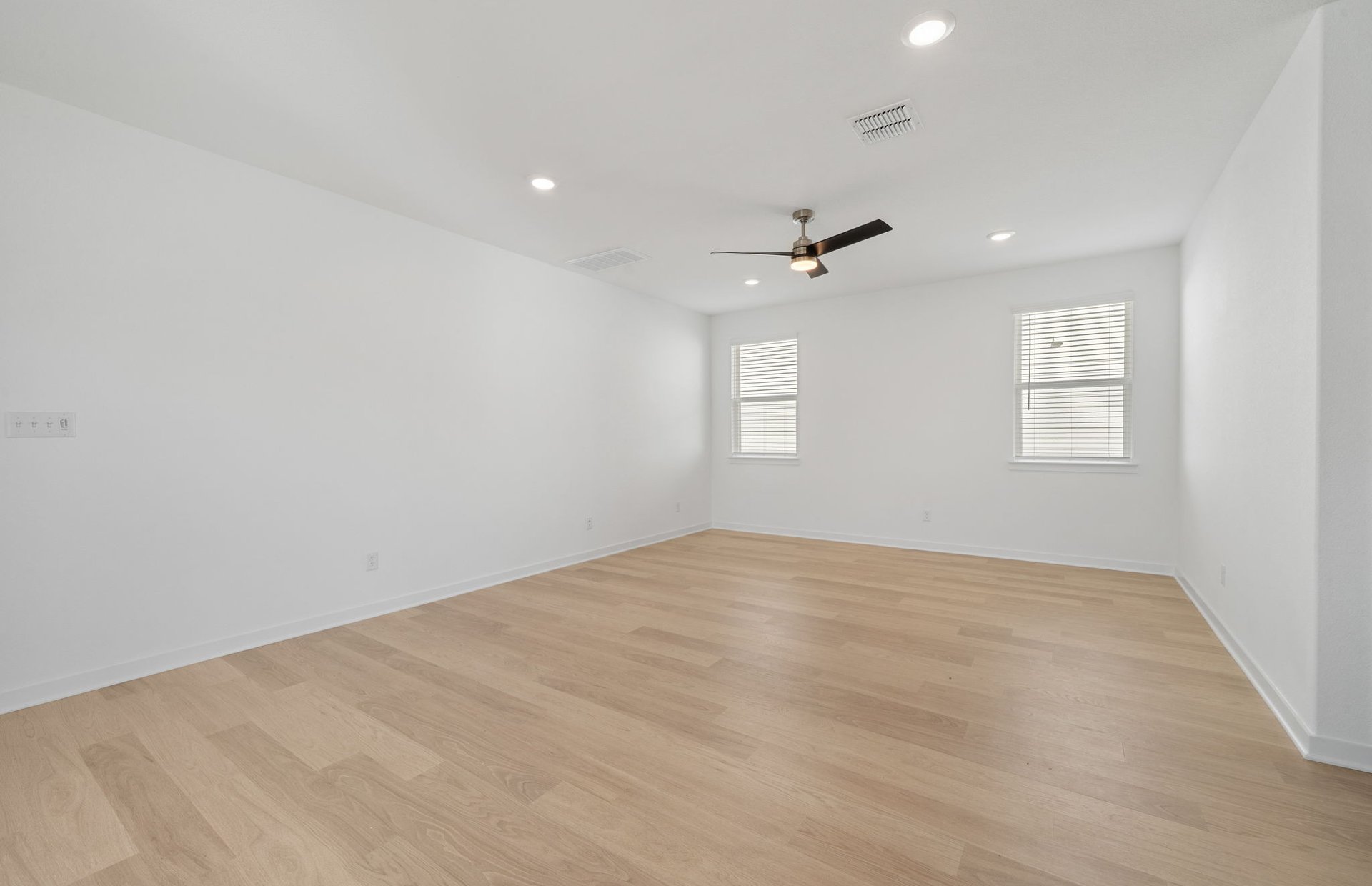 608 Rubber Tree Way Buda, TX 78610 - Photo 9 of 29 an empty room with windows and ceiling fan