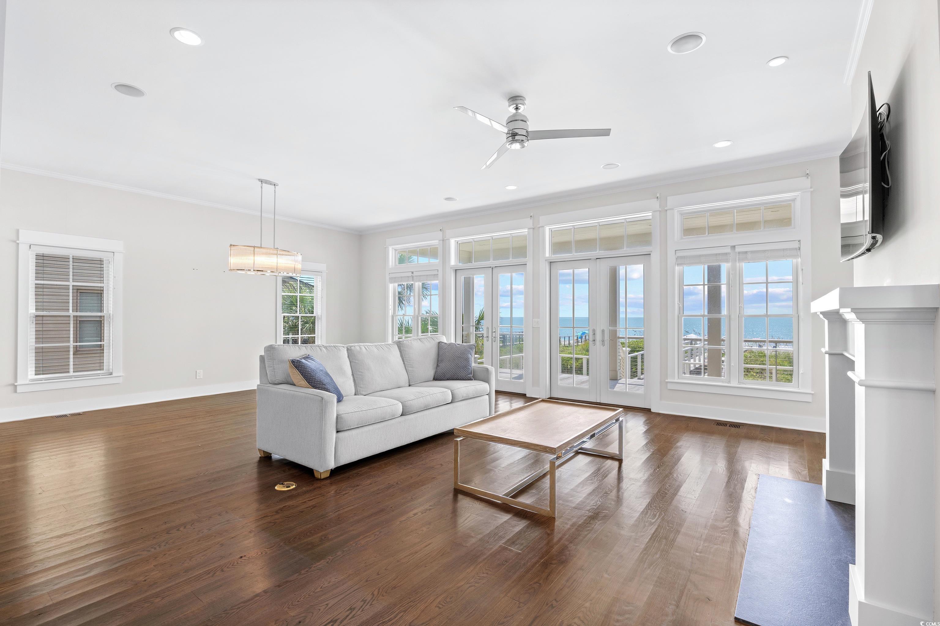40 Seaview Loop Pawleys Island, SC 29585 - Photo 11 of 34 Living area featuring dark wood-style floors, ceiling fan, ornamental molding, french doors, and recessed lighting