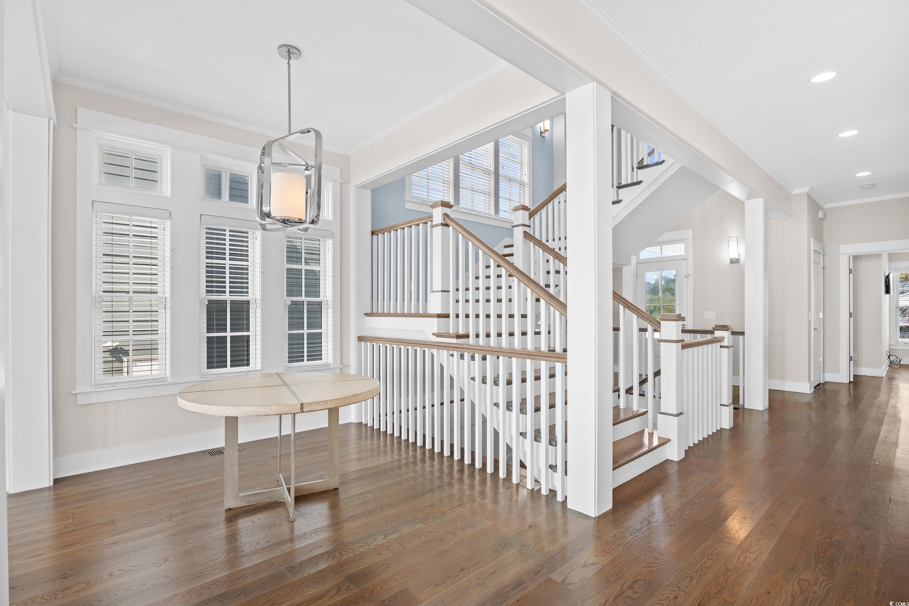 40 Seaview Loop Pawleys Island, SC 29585 - Photo 18 of 34 Staircase featuring crown molding and wood finished floors