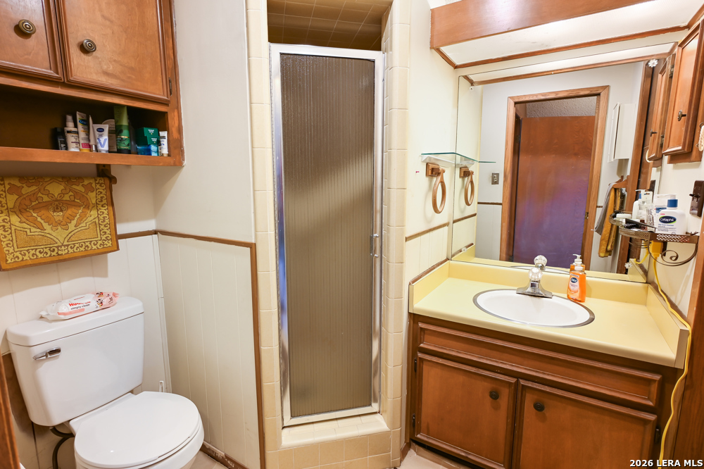 348 Rocky Road Pipe Creek, TX 78063 - Photo 30 of 41 a bathroom with a granite countertop sink toilet and shower