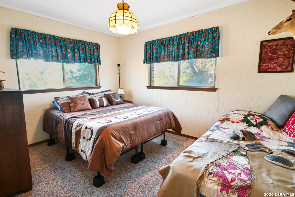 348 Rocky Road Pipe Creek, TX 78063 - Photo 35 of 41 a bedroom with a bed and a window
