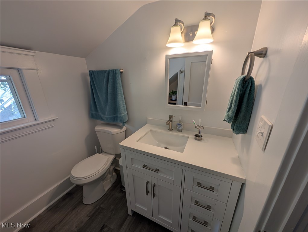 2108 Stillman Road, Unit 3 Cleveland, OH 44118 - Photo 10 of 14 Half bath with dark wood finished floors, vanity, and vaulted ceiling