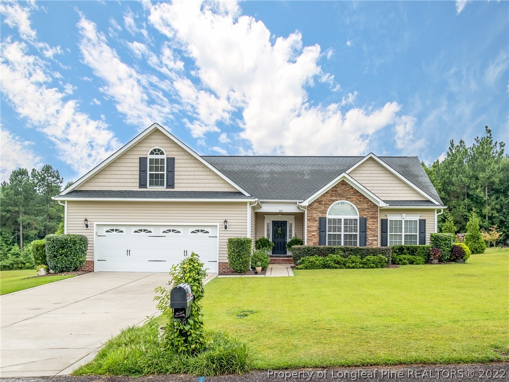 a front view of a house with garden