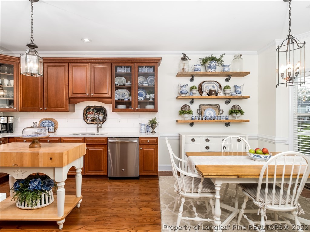 320 Porlock Way Raeford, NC 28376 - Photo 13 of 41 a kitchen with a dining table cabinets and appliances