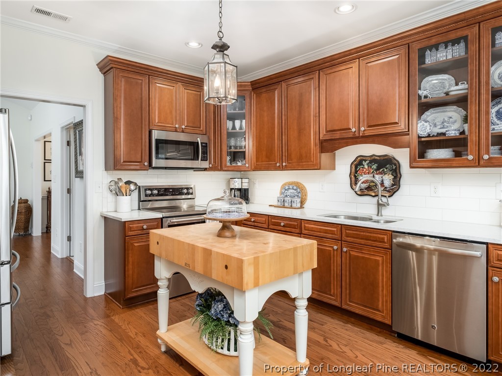 320 Porlock Way Raeford, NC 28376 - Photo 14 of 41 a kitchen with stainless steel appliances granite countertop a stove top oven a sink a refrigerator and a microwave