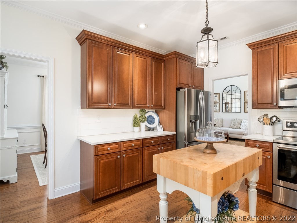 320 Porlock Way Raeford, NC 28376 - Photo 15 of 41 a kitchen with a sink a stove and chairs