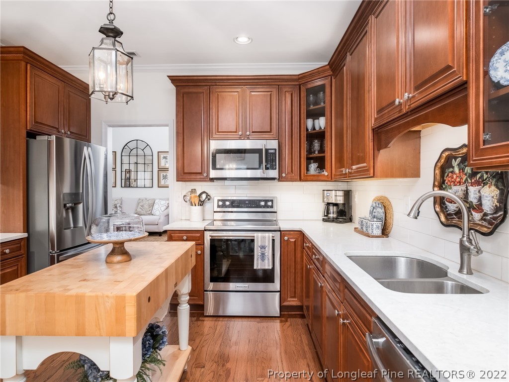 320 Porlock Way Raeford, NC 28376 - Photo 16 of 41 a kitchen with stainless steel appliances granite countertop a sink stove and refrigerator