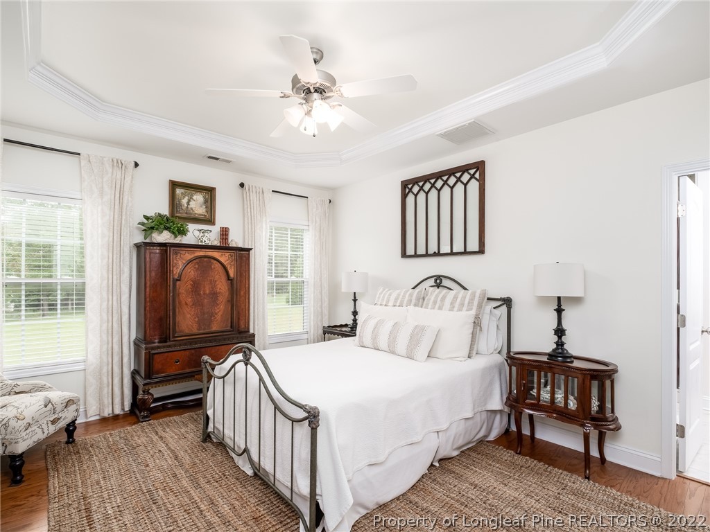 320 Porlock Way Raeford, NC 28376 - Photo 20 of 41 a bedroom with a bed and wooden floor